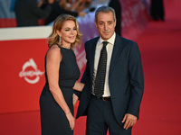 Claudia Gerini and Riccardo Sangiuliano attend the ''U.S. Palmese'' red carpet during the 19th Rome Film Festival at Auditorium Parco Della...