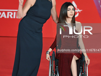 Claudia Gerini and a guest attend the ''U.S. Palmese'' red carpet during the 19th Rome Film Festival at Auditorium Parco Della Musica in Rom...