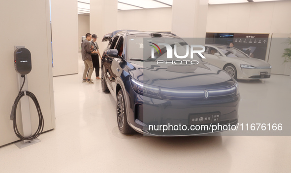 A customer experiences a smart car with Harmony OS autonomous driving technology at Huawei's flagship store in Shanghai, China, on October 1...