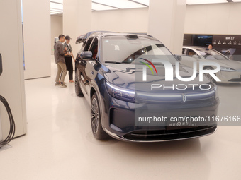 A customer experiences a smart car with Harmony OS autonomous driving technology at Huawei's flagship store in Shanghai, China, on October 1...