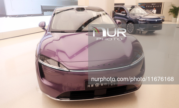 A smart car with Harmony OS autonomous driving technology is seen at Huawei's flagship store in Shanghai, China, on October 15, 2024. 