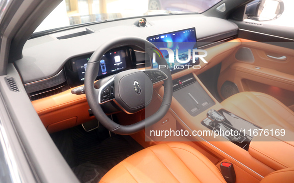 A smart car with Harmony OS autonomous driving technology is seen at Huawei's flagship store in Shanghai, China, on October 15, 2024. 