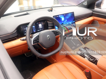 A smart car with Harmony OS autonomous driving technology is seen at Huawei's flagship store in Shanghai, China, on October 15, 2024. (