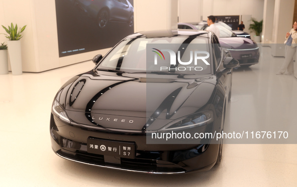 A smart car with Harmony OS autonomous driving technology is seen at Huawei's flagship store in Shanghai, China, on October 15, 2024. 