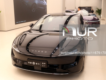 A smart car with Harmony OS autonomous driving technology is seen at Huawei's flagship store in Shanghai, China, on October 15, 2024. (