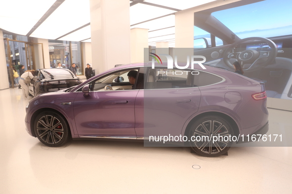 A smart car with Harmony OS autonomous driving technology is seen at Huawei's flagship store in Shanghai, China, on October 15, 2024. 