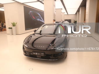 A smart car with Harmony OS autonomous driving technology is seen at Huawei's flagship store in Shanghai, China, on October 15, 2024. (