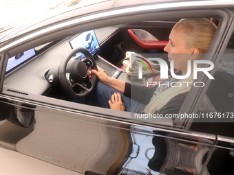 A customer experiences a smart car with Harmony OS autonomous driving technology at Huawei's flagship store in Shanghai, China, on October 1...