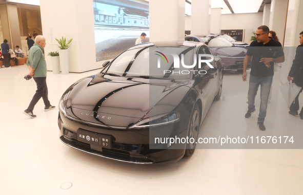 A customer experiences a smart car with Harmony OS autonomous driving technology at Huawei's flagship store in Shanghai, China, on October 1...