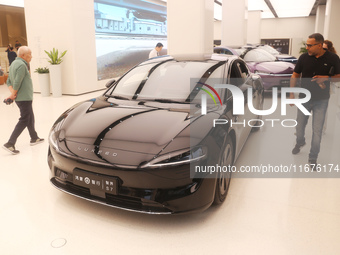 A customer experiences a smart car with Harmony OS autonomous driving technology at Huawei's flagship store in Shanghai, China, on October 1...