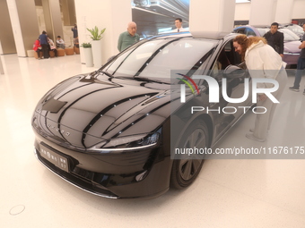 A customer experiences a smart car with Harmony OS autonomous driving technology at Huawei's flagship store in Shanghai, China, on October 1...