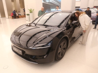 A customer experiences a smart car with Harmony OS autonomous driving technology at Huawei's flagship store in Shanghai, China, on October 1...