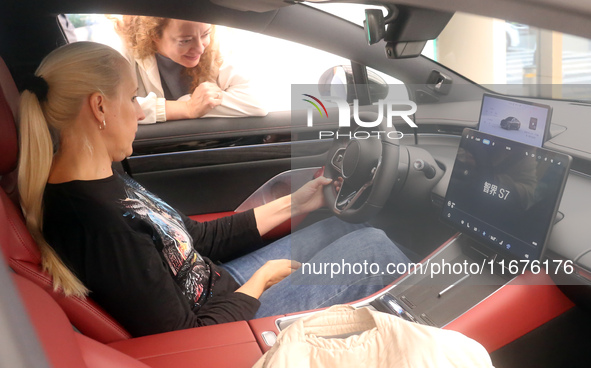 A customer experiences a smart car with Harmony OS autonomous driving technology at Huawei's flagship store in Shanghai, China, on October 1...