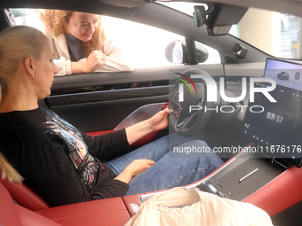 A customer experiences a smart car with Harmony OS autonomous driving technology at Huawei's flagship store in Shanghai, China, on October 1...