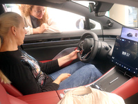 A customer experiences a smart car with Harmony OS autonomous driving technology at Huawei's flagship store in Shanghai, China, on October 1...