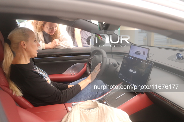 A customer experiences a smart car with Harmony OS autonomous driving technology at Huawei's flagship store in Shanghai, China, on October 1...