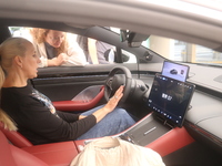 A customer experiences a smart car with Harmony OS autonomous driving technology at Huawei's flagship store in Shanghai, China, on October 1...