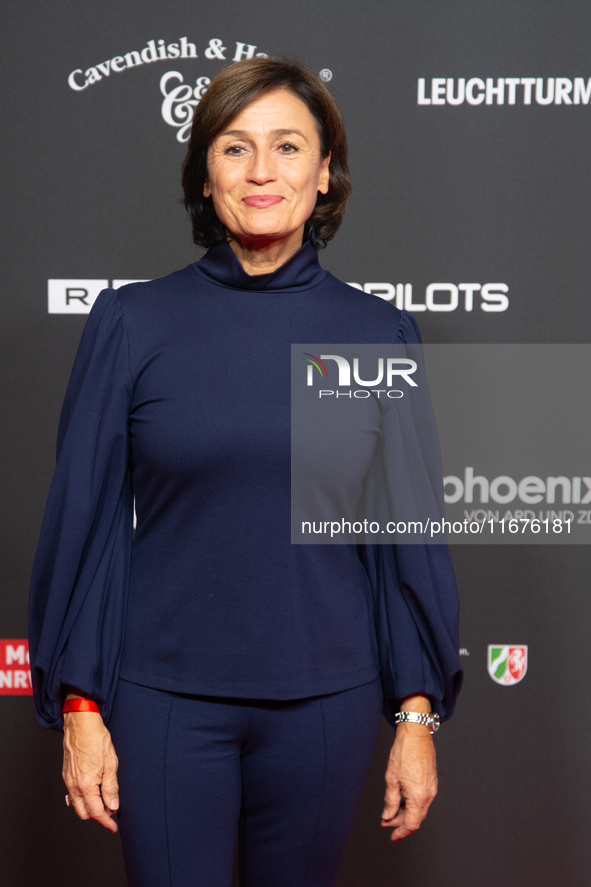 Sandra Maischberger, a German talk show host, stands on the red carpet during the opening of the Cologne Film Festival 2024 at Film Palast i...