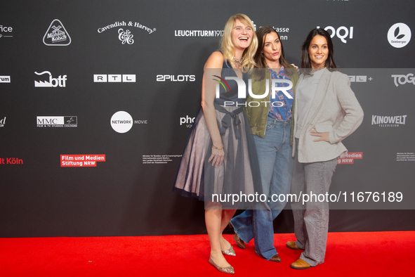 Corinna Nilson, a German actress, Antje Hamer, a German actress, and Leni Adams, a German actress, stand on the red carpet during the openin...