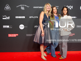 Corinna Nilson, a German actress, Antje Hamer, a German actress, and Leni Adams, a German actress, stand on the red carpet during the openin...