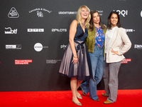 Corinna Nilson, a German actress, Antje Hamer, a German actress, and Leni Adams, a German actress, stand on the red carpet during the openin...