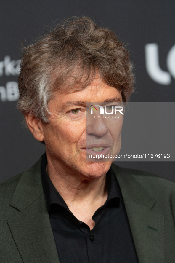 Andres Veiel, a German director, stands on the red carpet during the opening of the Cologne Film Festival 2024 at Film Palast in Cologne, Ge...