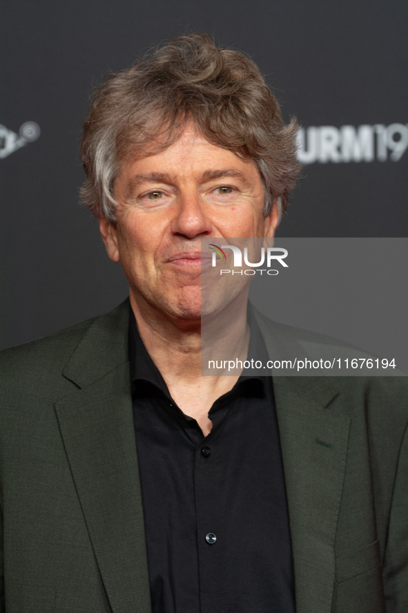 Andres Veiel, a German director, stands on the red carpet during the opening of the Cologne Film Festival 2024 at Film Palast in Cologne, Ge...