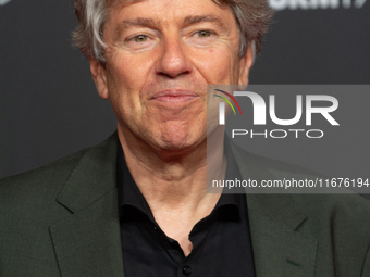 Andres Veiel, a German director, stands on the red carpet during the opening of the Cologne Film Festival 2024 at Film Palast in Cologne, Ge...