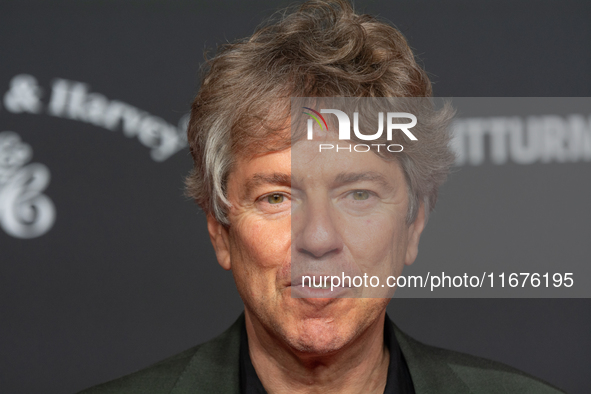 Andres Veiel, a German director, stands on the red carpet during the opening of the Cologne Film Festival 2024 at Film Palast in Cologne, Ge...