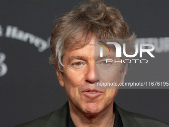 Andres Veiel, a German director, stands on the red carpet during the opening of the Cologne Film Festival 2024 at Film Palast in Cologne, Ge...