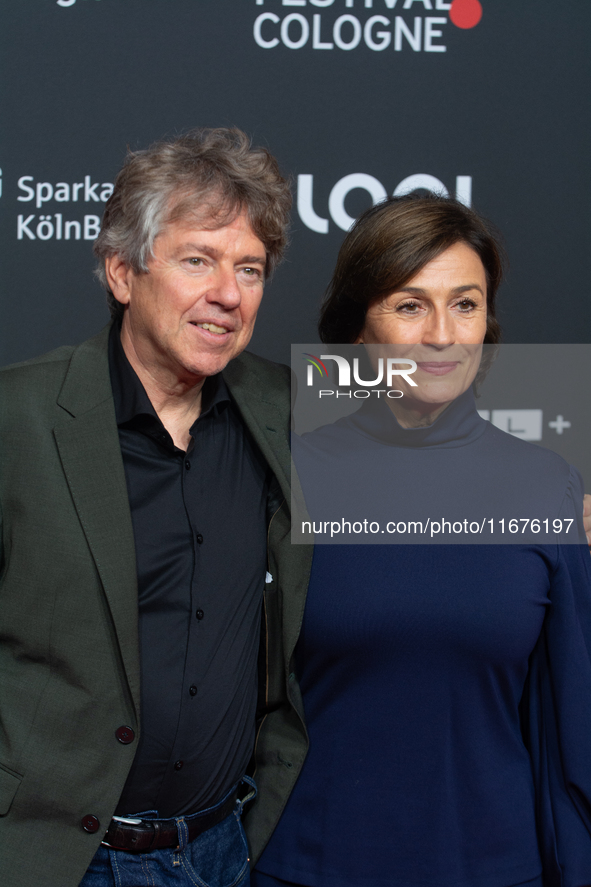 Andres Veiel, a German director, and Sandra Maischberger, a German talk show host, stand on the red carpet during the opening of the Cologne...