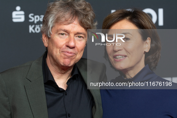 Andres Veiel, a German director, and Sandra Maischberger, a German talk show host, stand on the red carpet during the opening of the Cologne...