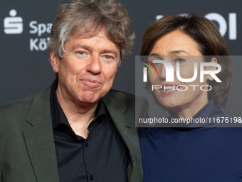 Andres Veiel, a German director, and Sandra Maischberger, a German talk show host, stand on the red carpet during the opening of the Cologne...