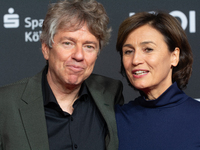 Andres Veiel, a German director, and Sandra Maischberger, a German talk show host, stand on the red carpet during the opening of the Cologne...