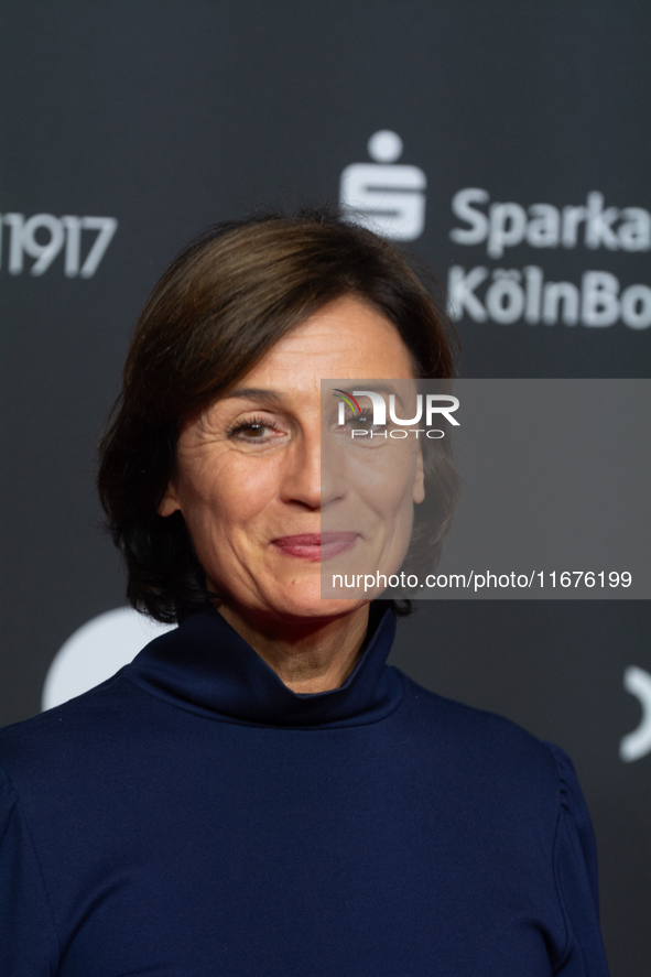 Sandra Maischberger, a German talk show host, stands on the red carpet during the opening of the Cologne Film Festival 2024 at Film Palast i...