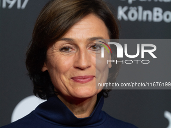 Sandra Maischberger, a German talk show host, stands on the red carpet during the opening of the Cologne Film Festival 2024 at Film Palast i...