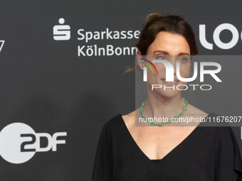 Stefanie Wilpert, a German actress, stands on the red carpet during the opening of the Cologne Film Festival 2024 at Film Palast in Cologne,...