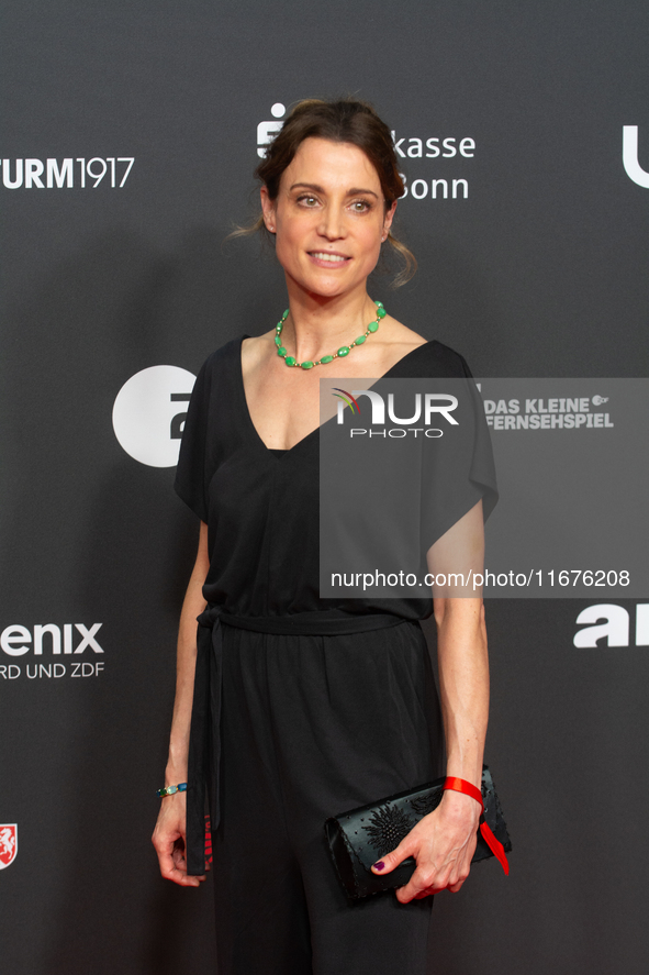 Stefanie Wilpert, a German actress, stands on the red carpet during the opening of the Cologne Film Festival 2024 at Film Palast in Cologne,...