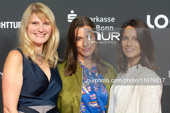 Corinna Nilson, a German actress, Antje Hamer, a German actress, and Leni Adams, a German actress, stand on the red carpet during the openin...