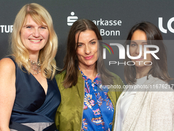 Corinna Nilson, a German actress, Antje Hamer, a German actress, and Leni Adams, a German actress, stand on the red carpet during the openin...