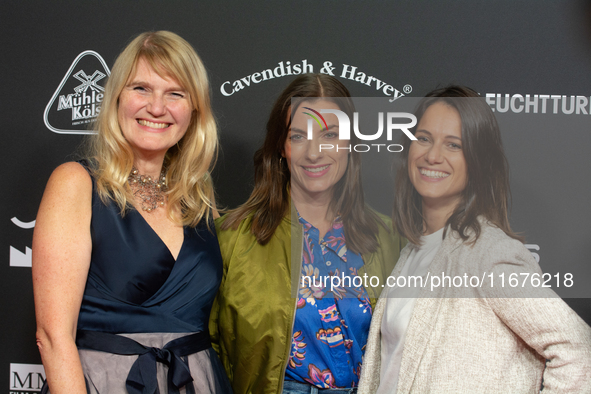 Corinna Nilson, a German actress, Antje Hamer, a German actress, and Leni Adams, a German actress, stand on the red carpet during the openin...