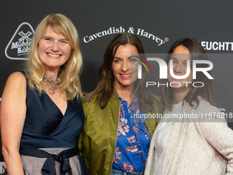 Corinna Nilson, a German actress, Antje Hamer, a German actress, and Leni Adams, a German actress, stand on the red carpet during the openin...