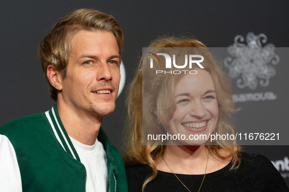 Madeleine Krakor, a German actress, and Sebastian Kolb, a German actor, stand on the red carpet during the opening of the Cologne Film Festi...