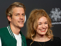 Madeleine Krakor, a German actress, and Sebastian Kolb, a German actor, stand on the red carpet during the opening of the Cologne Film Festi...