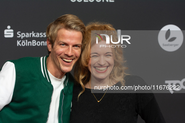 Madeleine Krakor, a German actress, and Sebastian Kolb, a German actor, stand on the red carpet during the opening of the Cologne Film Festi...