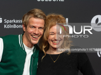 Madeleine Krakor, a German actress, and Sebastian Kolb, a German actor, stand on the red carpet during the opening of the Cologne Film Festi...