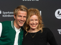 Madeleine Krakor, a German actress, and Sebastian Kolb, a German actor, stand on the red carpet during the opening of the Cologne Film Festi...