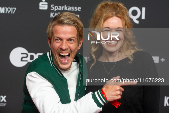 Madeleine Krakor, a German actress, and Sebastian Kolb, a German actor, stand on the red carpet during the opening of the Cologne Film Festi...