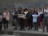 A group of passers-by watches a police operation after an attack on Diana Sanchez Barrios, leader of traders in the Historic Centre of Mexic...