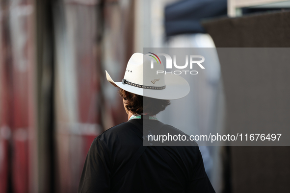 A man wears a COTA-themed cowboy hat in the paddock at Circuit of the Americas in Austin, Texas, on October 17, 2024. 